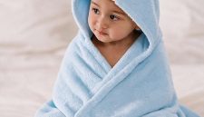 Little Luxuries by MIKI HOUSE di The Ritz-Carlton, Bali. Seorang bayi mengenakan ponco mandi premium MIKI HOUSE yang dibuat dari 100% katun untuk menjaga kehangatan dan kenyamanan si kecil setelah setiap mandi atau berenang.